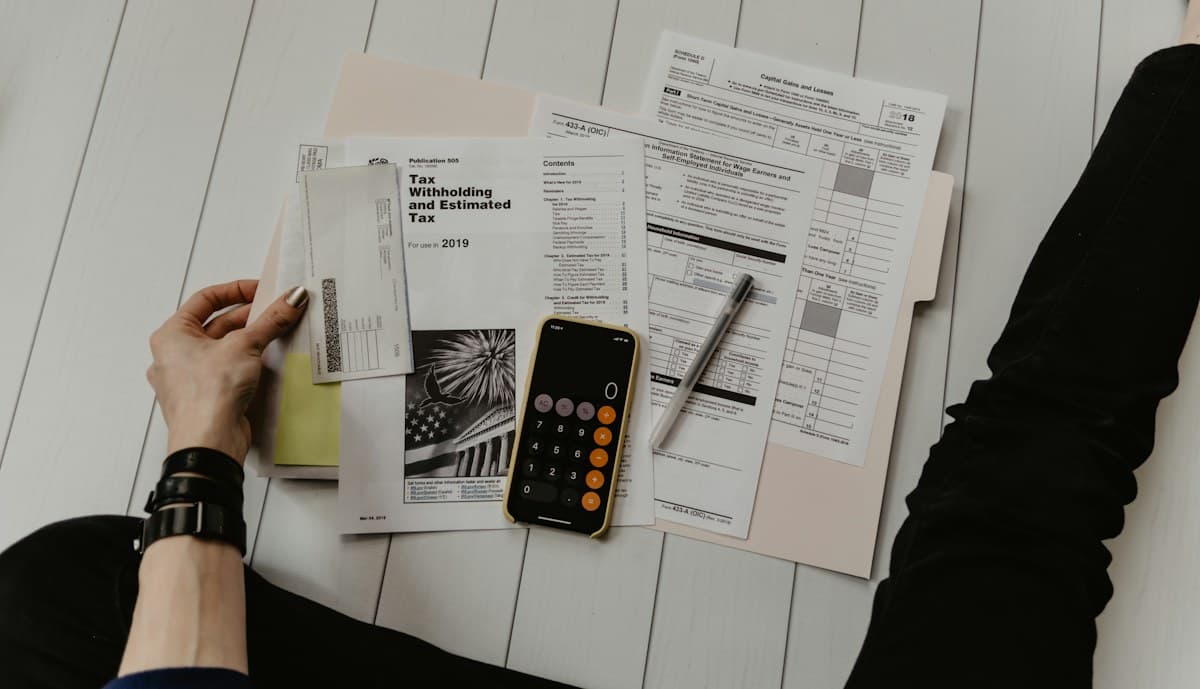 A calculator beside household financial paperwork